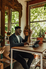 Adult black man, waving to his friend across the globe.