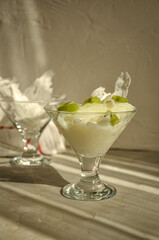 Traditional Ramadan Dessert Gullac on the table. It is made with gullac, milk, rose water, walnut, vanilla. It is decorated with kiwi.