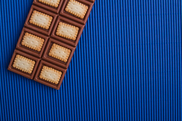 Top view flat lay mix of chocolate bar and cookie.