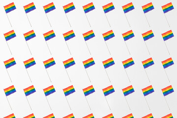 Lgtbi community rainbow flags pattern with hard shadow on white background. Pride day concept