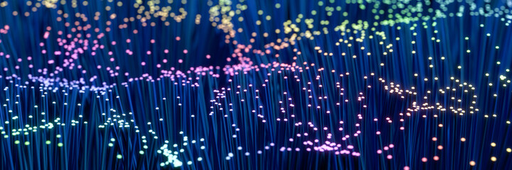 Fiber Optic Cable technology background in blue and rainbow colors with selective focus. Web banner...