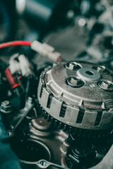 Close-up of motorcycle engine clutch system in maintenance checks.