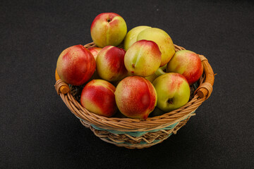 Sweet small nectarines in the basket