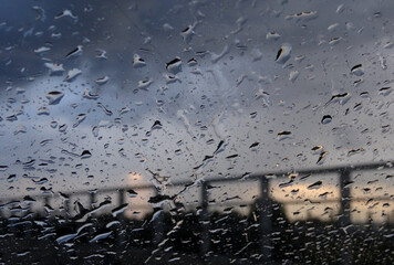 Look On Cloudy Sky Through Raindrops On A Window