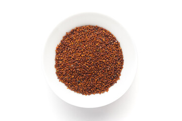 Macro close-up of Organic red-brown small mustard seed (Brassica nigra)  on white background. Pile of Indian Aromatic Spice. Top view