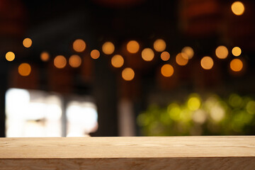 empty table to showcase your product, against a blurred coffee golden bokeh background. With panoramic windows