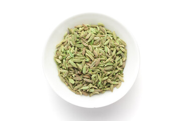 Macro close-up of Organic Fennel Seeds (Foeniculum vulgare) Badi sonf on white background. Pile of Indian Aromatic Spice. Top view