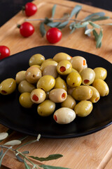 Green olives stuffed with peppers. Delicious green olives on the plate.