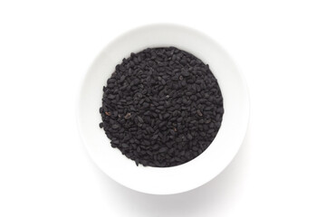 Macro close-up of Organic black cumin  (Nigella sativa) or kalonji on white background. Pile of...