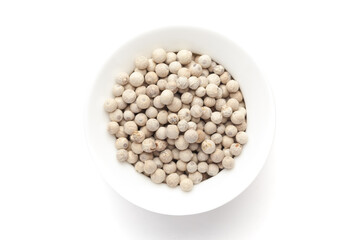 Macro close-up of Organic White peppercorns (Piper nigrum) on white background. Pile of Indian Aromatic Spice. Top view