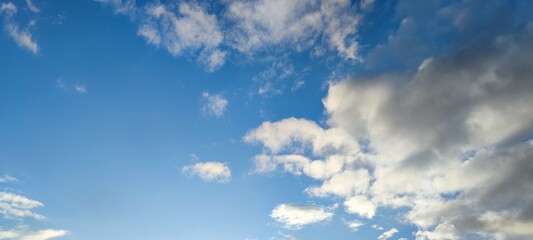 Light white cloud against the blue sky. A small, scattered white cloud floats across the sky next to the sun. The color of the sky changes from light blue to dark blue.