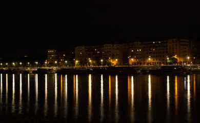 Fototapeta na wymiar landscape with city lights reflected in the lake water