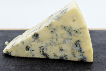 dor blue cheese, delicious cheese with mold and grapes, close-up.