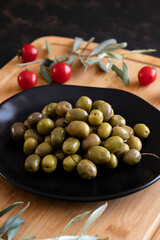 Organic green olives. Tasty green olives in the plate.