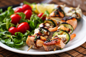 Fish skewers with mixed salad. High quality photo.