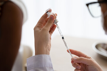 Doctor or scientist carries a syringe and a vaccine against COVID-19, vaccination and laboratory...