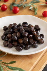 Organic black olives. Delicious black olives on the plate.