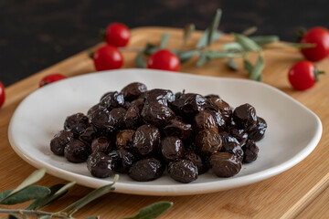 Organic black olives. Delicious black olives on the plate.