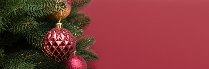 Banner with trendy Christmas decorations. New Year ornaments in front of red background with copy space.