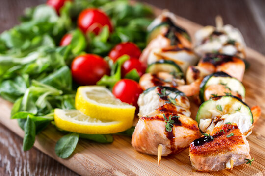 Fish skewers with mixed salad. High quality photo.