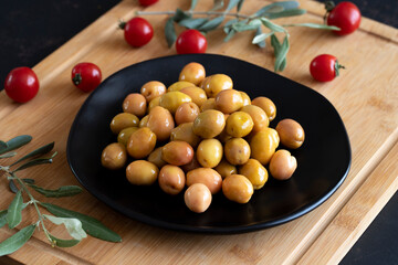 Delicious green olives. Tasty green olives in the plate.