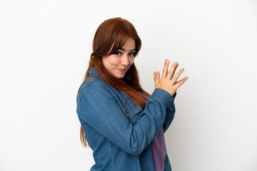 Young redhead woman isolated on white background scheming something