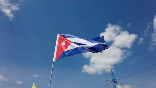 Cuba. National country flag on blue sky background. Flying fabric symbol. Tourism or travel summer day. international patriotic emblem. Nobody. Horizontal video