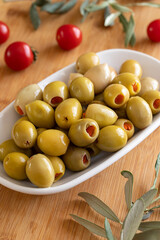 Green olives stuffed with peppers. Tasty organic green olives in the plate. Stuffed olives on...