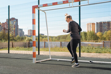 Woman in sportswear fitness outdoor training in summer. Fitness athlete jogging in place for weight loss. Active lifestyle.