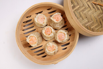 Prawn shrimp shaomai dim sum dumpling in bamboo steamer on white background