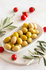 Yellow kalamata olives. Tasty organic yellow olives in the plate. Olive on marble floor