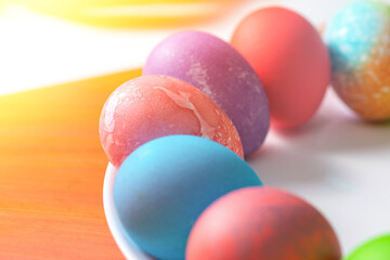 Painted eggs for Easter on a plate. Plate on a brown table. 