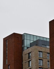 Looking up at modern buildings with a cloudy sky background. Taken in Manchester England. 