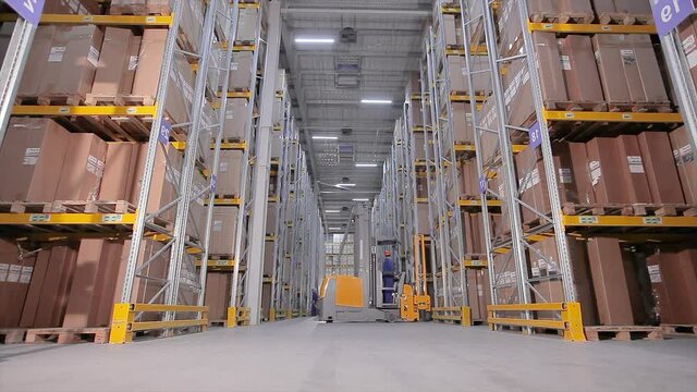 Workflow in warehouse, large machine in warehouse, modern forklift in warehouse