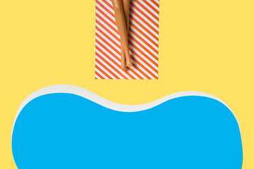 Summer vacation layout with doll legs on beach towels