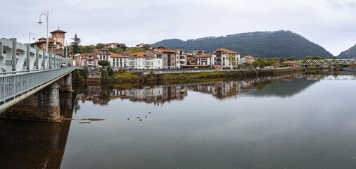 Panorámica de las vistas del río Deva reflejando en sus aguas el pueblo de Unquera en Cantabria, verano de 2020