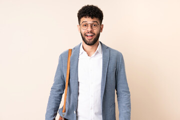Fototapeta premium Young business Moroccan man isolated on beige background with surprise facial expression