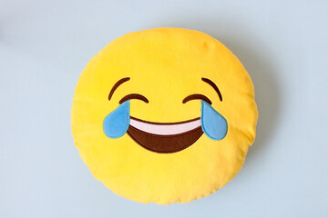 laughing emoji emoticon pillow on color background