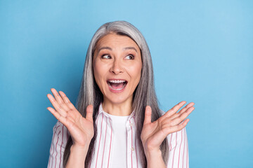 Photo of aged woman happy positive simile amazed surprised news sale look empty space isolated over blue color background - obrazy, fototapety, plakaty
