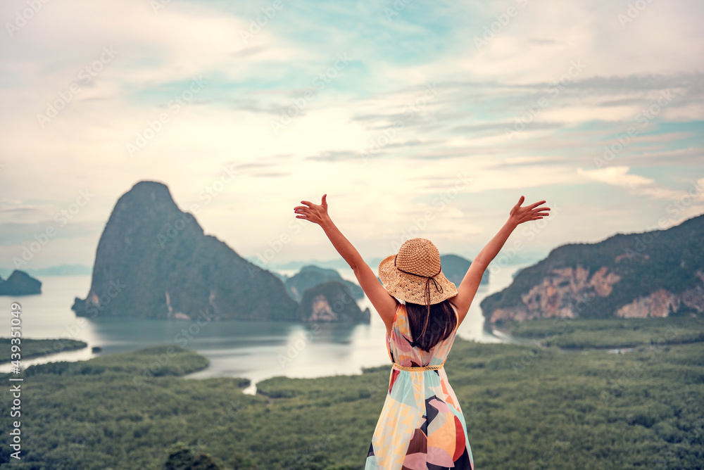 Wall mural Freedom traveler woman relaxing with raised arms on the top of mountain at Thailand, Enjoy travel concept.