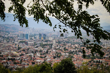 View of Sarajevo through the canopy of trees. Panorama of Sarajevo. Sarajevo, the capital of Bosnia...