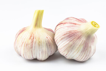 Obraz premium Two large heads of garlic isolated on a white background.