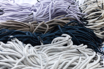 Background of many colorful synthetic handle cord for paper packets. Part of the packaging bags.