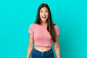 Young Brazilian woman isolated on blue background with surprise facial expression