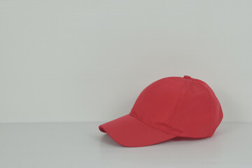 Red baseball cap or red hat on white background.