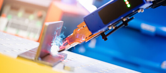 Close-up of nozzle for robotic welding, banner automatic industrial production
