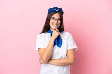 Airplane stewardess Brazilian woman isolated on pink background with glasses and smiling