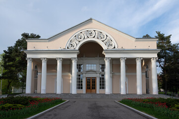Naklejka premium Building - example of soviet architecture with columns and soviet symbols. Inscription 