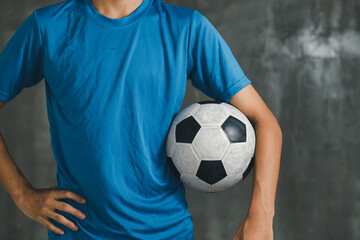 boy wearing blue shirt holding a classic football