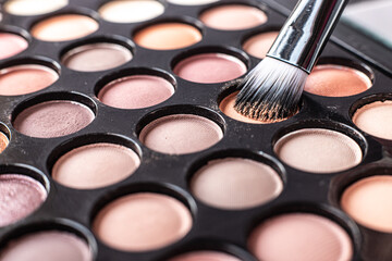 eye shadow is close. A makeup brush with eye shadow on it scatters the grains. macro palettes with shadows